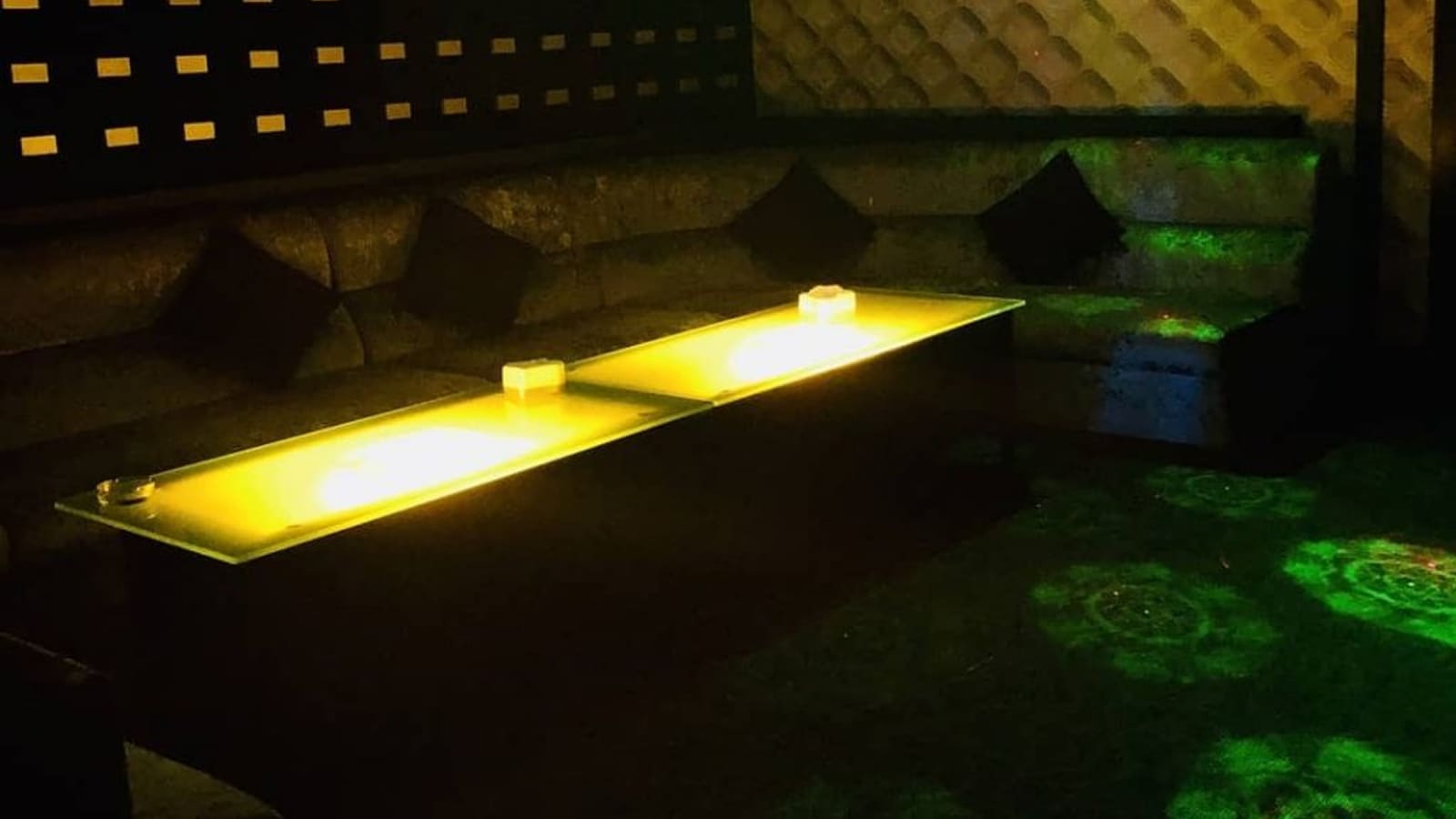 Private room with a lit table and padded walls at V3 KTV, Pulau Tikus, Penang
